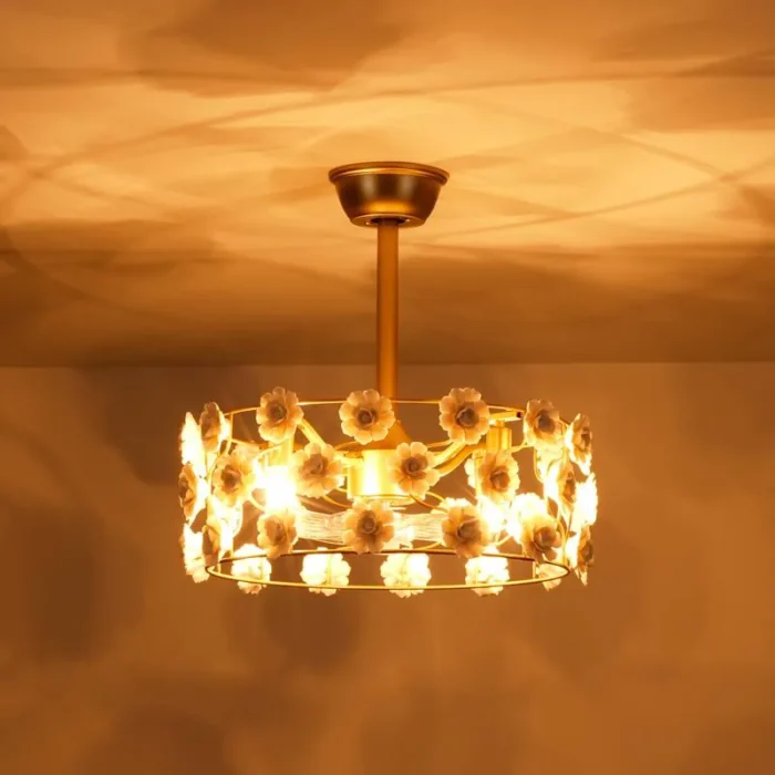 Warm glowing night view of ceramic flower ceiling fan in dark room