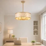 modern coastal capiz shell chandelier hanging above a wooden dining table