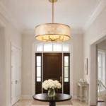 modern coastal capiz shell chandelier hanging above a wooden dining table