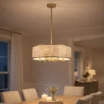 modern gold capiz shell drum chandelier hanging above a wooden dining table in a cozy dining room