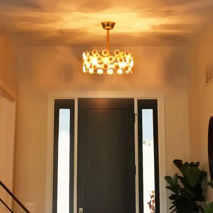 Warm glowing night view of ceramic flower ceiling fan in dark room